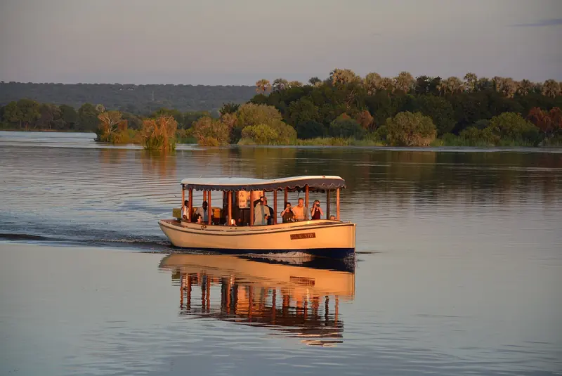 A riverboat on the Zambezi River in warm evening light